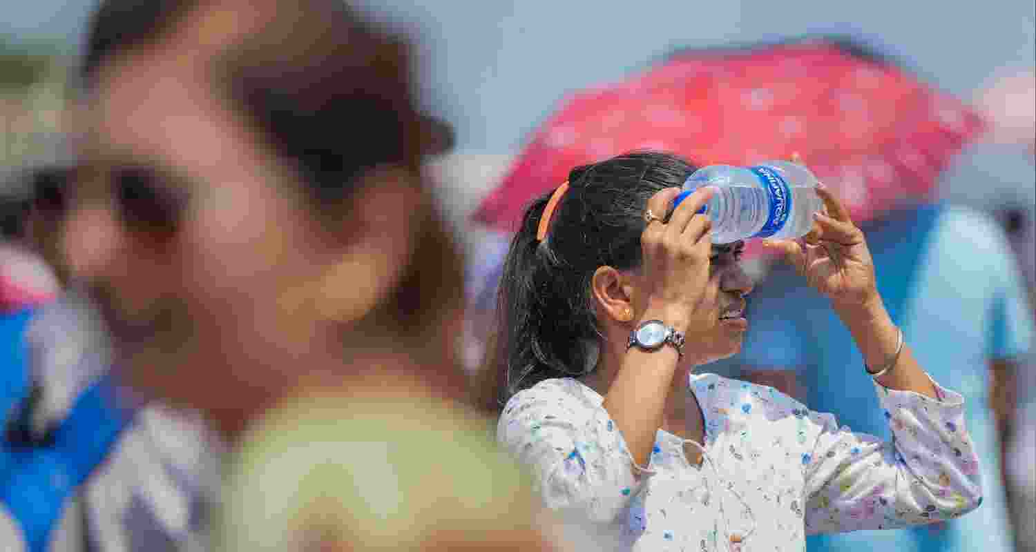 A woman holds a cold water bottle against her face amid the ongoing heatwave, April heatwave in South Asia made 45 times more likely by climate crisis: Scientists