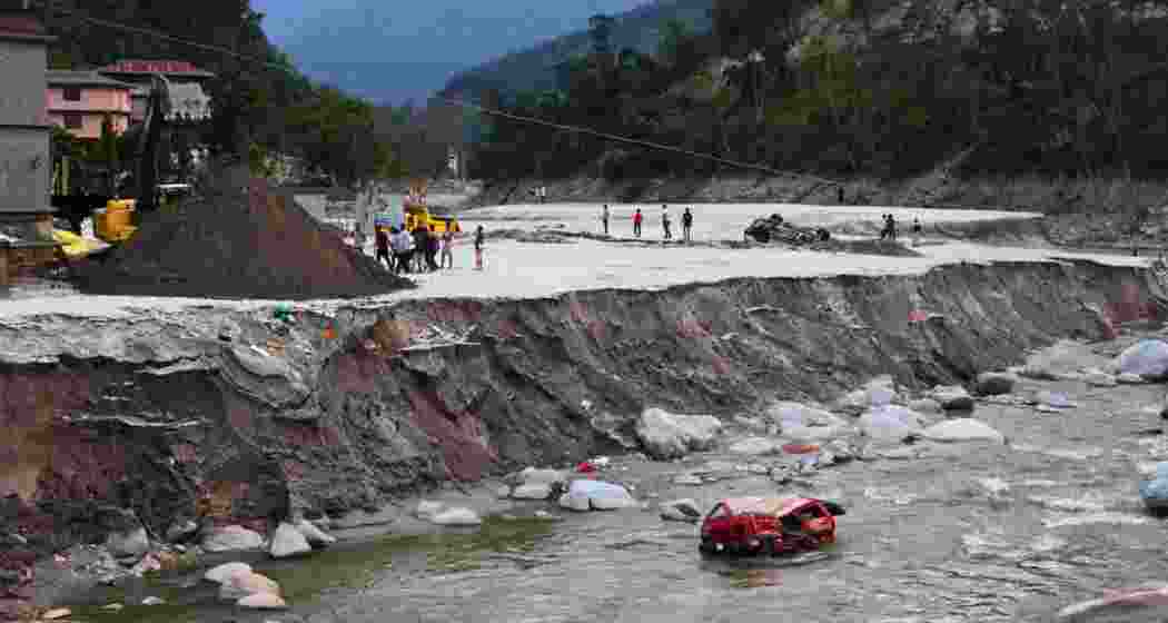 A view of damaged vehicles after flash floods, caused by a lake burst in Chungtham, Sikkim, on October 8.