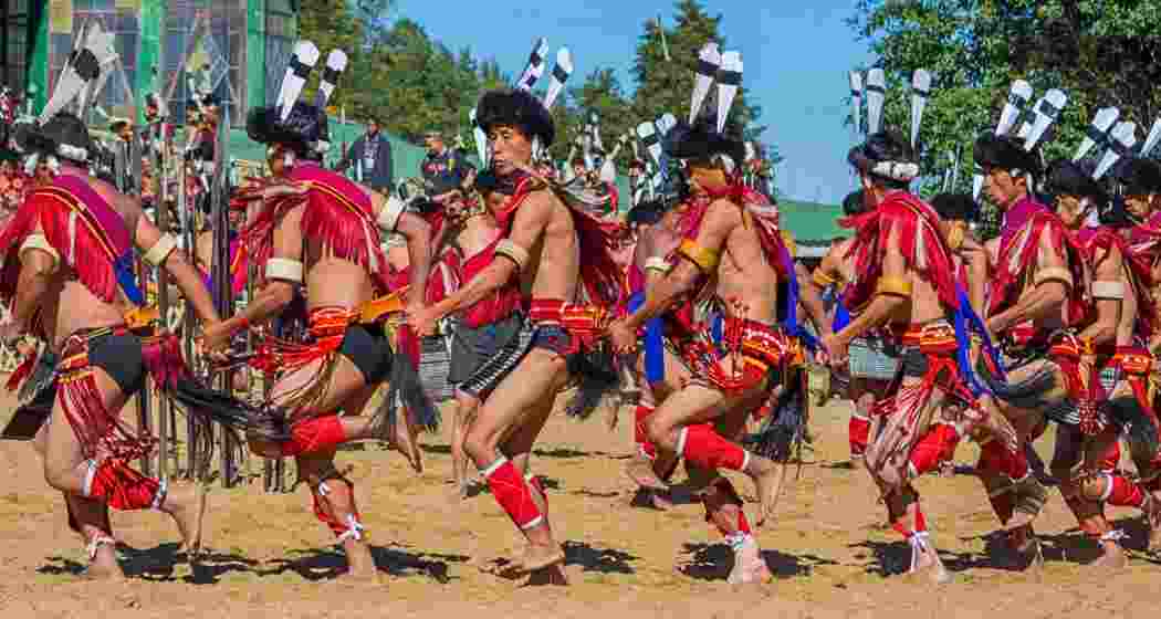 Performers dressed in traditional Naga attire prepare for the 25th Hornbill Festival.