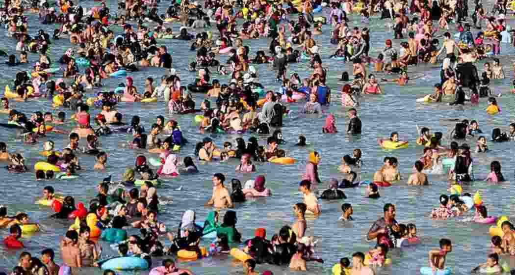 People crowd a public beach during a hot day amid a heatwave, in the Mediterranean city of Alexandria.