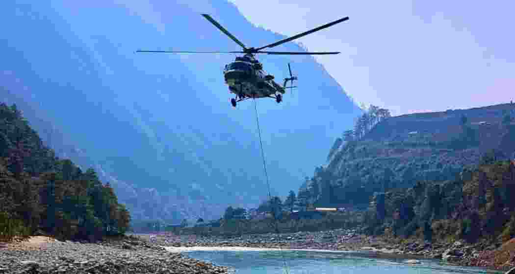 IAF helicopters conduct aerial firefighting operations over forest areas in Arunachal Pradesh’s East Siang district after a blaze spread across reserve and community forests in the Mebo sub-division.