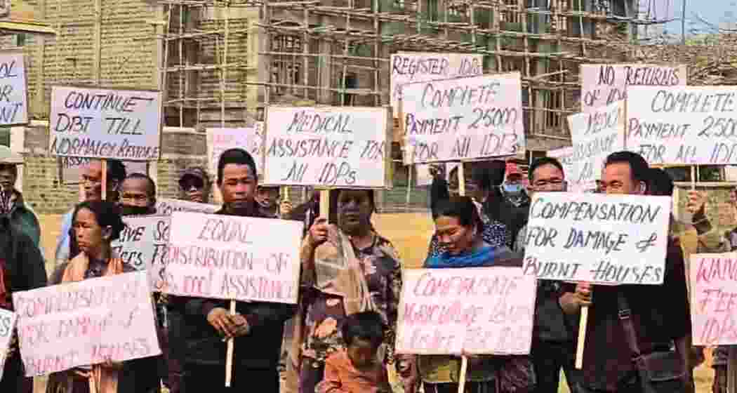 Internally displaced persons from Kangpokpi district hold placards at Keithelmanbi Military Colony, demanding justice, full compensation and rehabilitation before returning home amid ongoing government rehabilitation plans. Internally displaced persons from Kangpokpi district hold placards at Keithelmanbi Military Colony, demanding justice, full compensation and rehabilitation before returning home amid ongoing government rehabilitation plans.