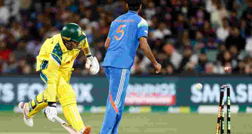 Australia's Alex Carey runs to make his ground as India's Washington Sundar watches during the one day international cricket match between Australia and India in Adelaide.