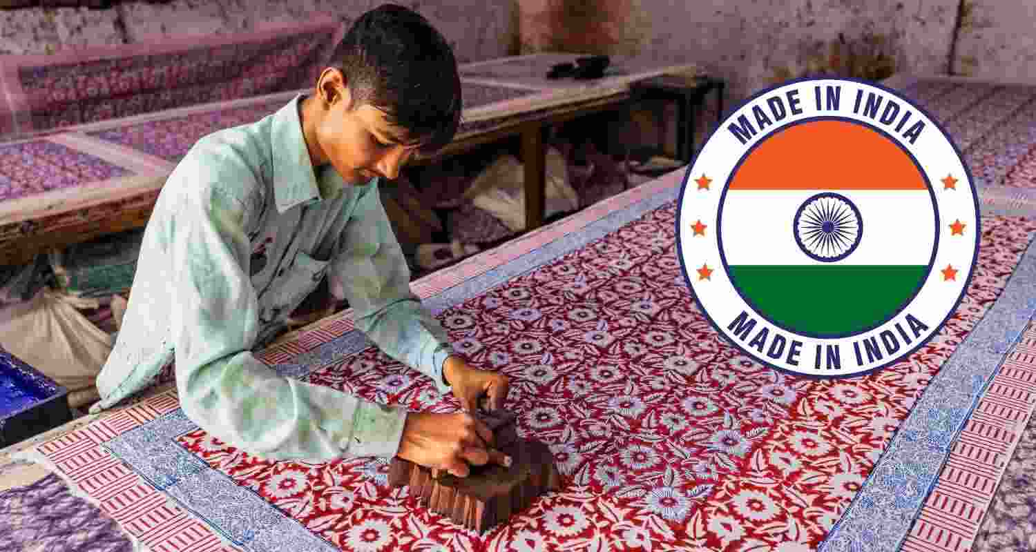 An artisan finishing up a block printed article.