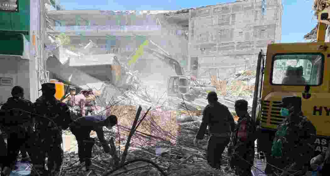 Rescuers clear rubble as they search for victims after a building collapsed at an Islamic boarding school in Sidoarjo, East Java, Indonesia.