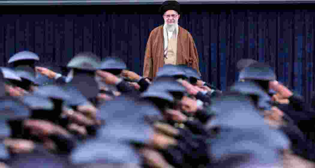 Iran's Supreme Leader Ayatollah Ali Khamenei listens to the national anthem as Air Force officers salute during their meeting in Tehran, Iran.