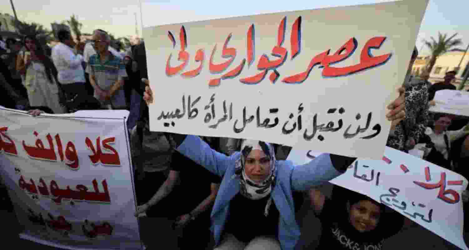 A protester holds a sign against deprivation of women's rights in marriage in Baghdad, Iraq, in August 2024. Image: X