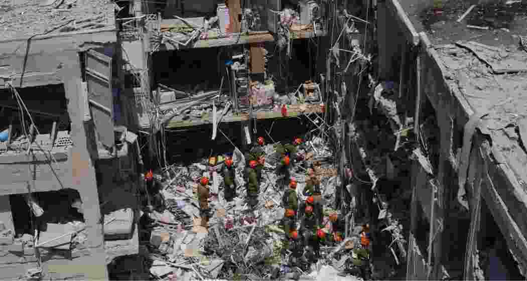 Israeli soldiers dig through rubble to search for survivors in a residential area hit by a missile fired from Iran, in Bat Yam, central Israel, Sunday.