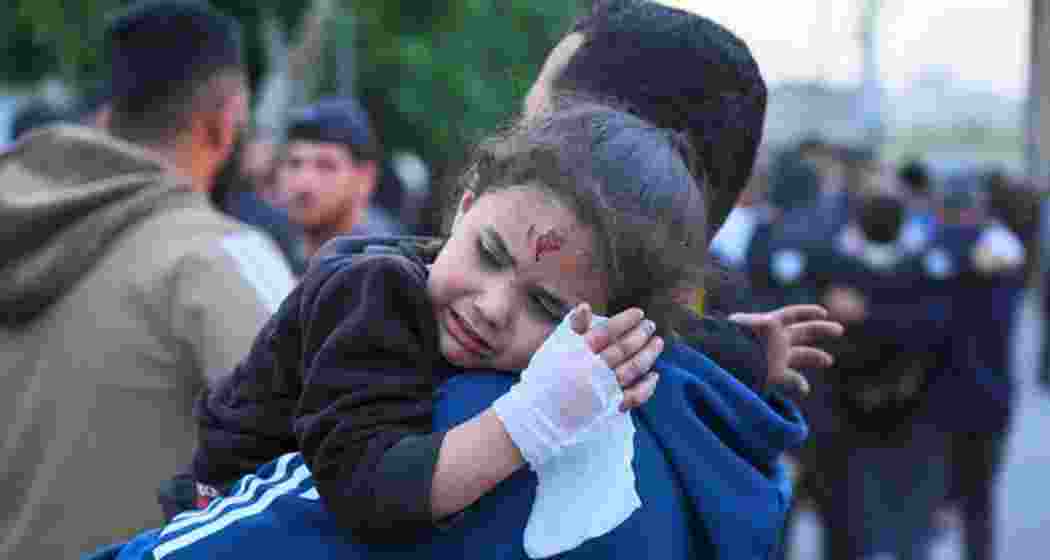A young Palestinian girl, injured in an Israeli airstrike, arrives at hospital in Gaza City on Thursday.