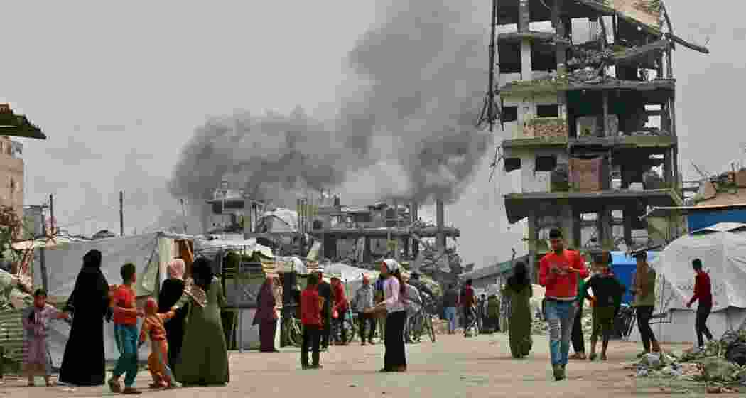 Palestinians flee for cover as an Israeli strike hits a residential area in Jabalia, northern Gaza Strip, on May 15, 2025.