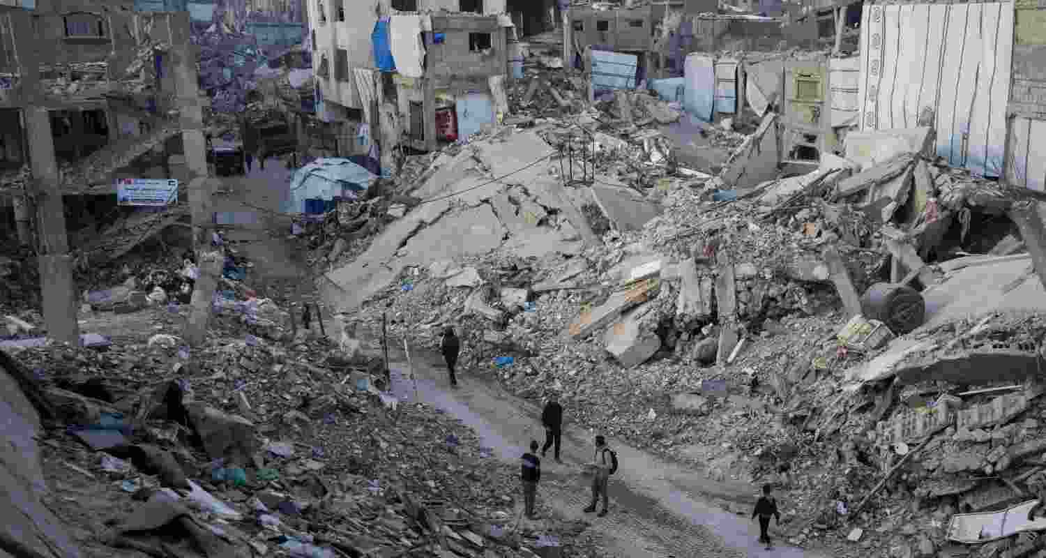 Locals walk in a road between rubble in Jabaliya, Gaza. Major infrastructure in the region has been severely damaged by the Israeli offensive against the Hamas terrorist group.