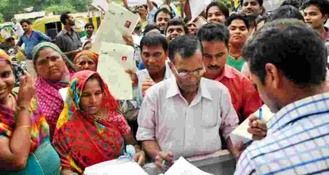 Account holders protest as an official records details of PMJDY beneficiaries.