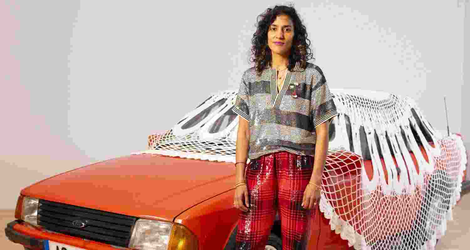 Glasgow-born artist of Indian heritage Jasleen Kaur with her artwork. Image: X