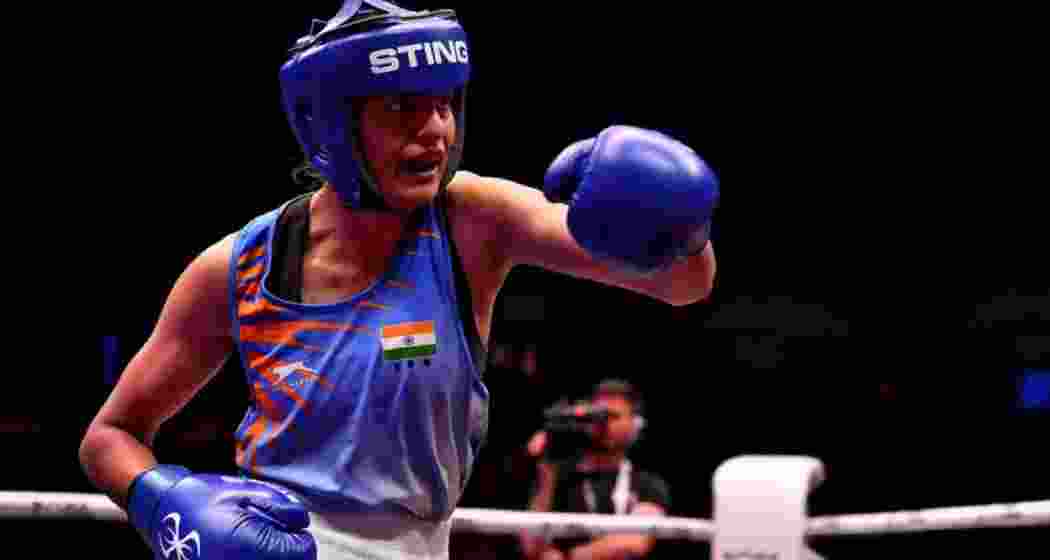 Indian boxer Jasmine Lamboria throws a punch during a bout.