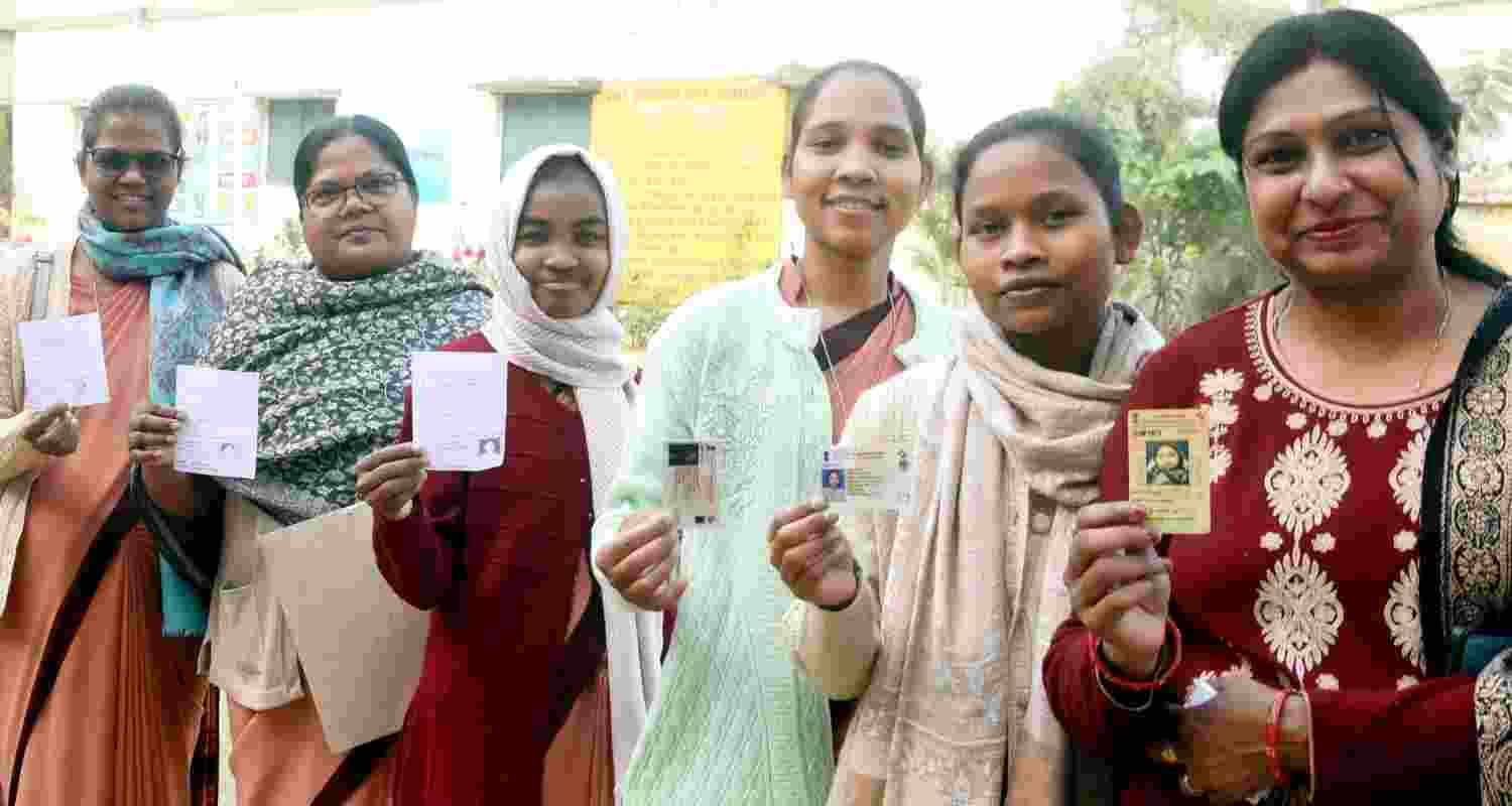 Voters stand in queues to cast their votes during the Ranchi Municipal Corporation (RMC) election, at a polling station, in Ranchi, Jharkhand. 