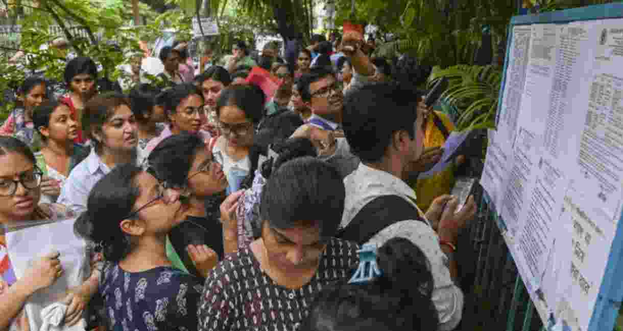 Candidates check their seating arrangements before appearing for a West Bengal School Service Commission’s (WBSSC) school staff recruitment examination, at an exam centre, in Kolkata, West Bengal - file image.