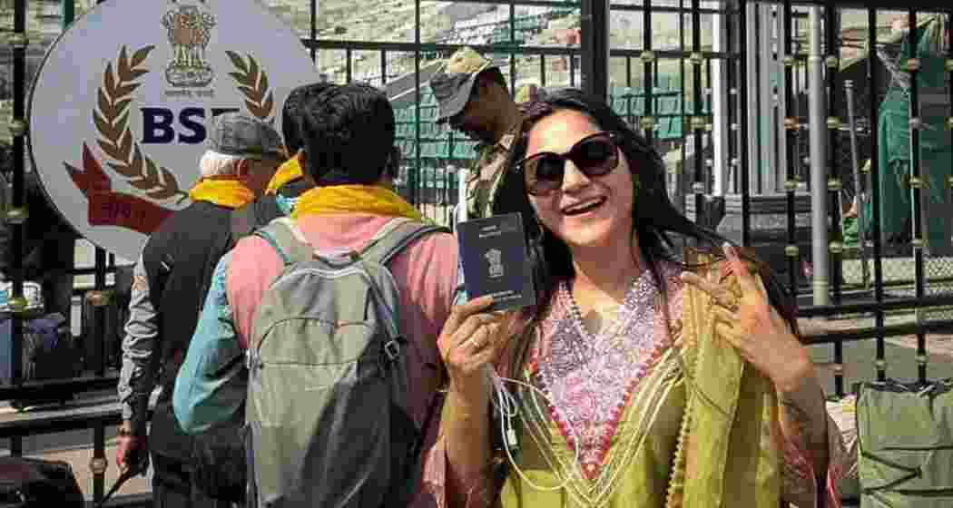 YouTuber Jyoti Malhotra seen displaying her passport during her Pakistan visit, as captured near the international border—now under scrutiny amid espionage allegations and an ongoing NIA investigation.