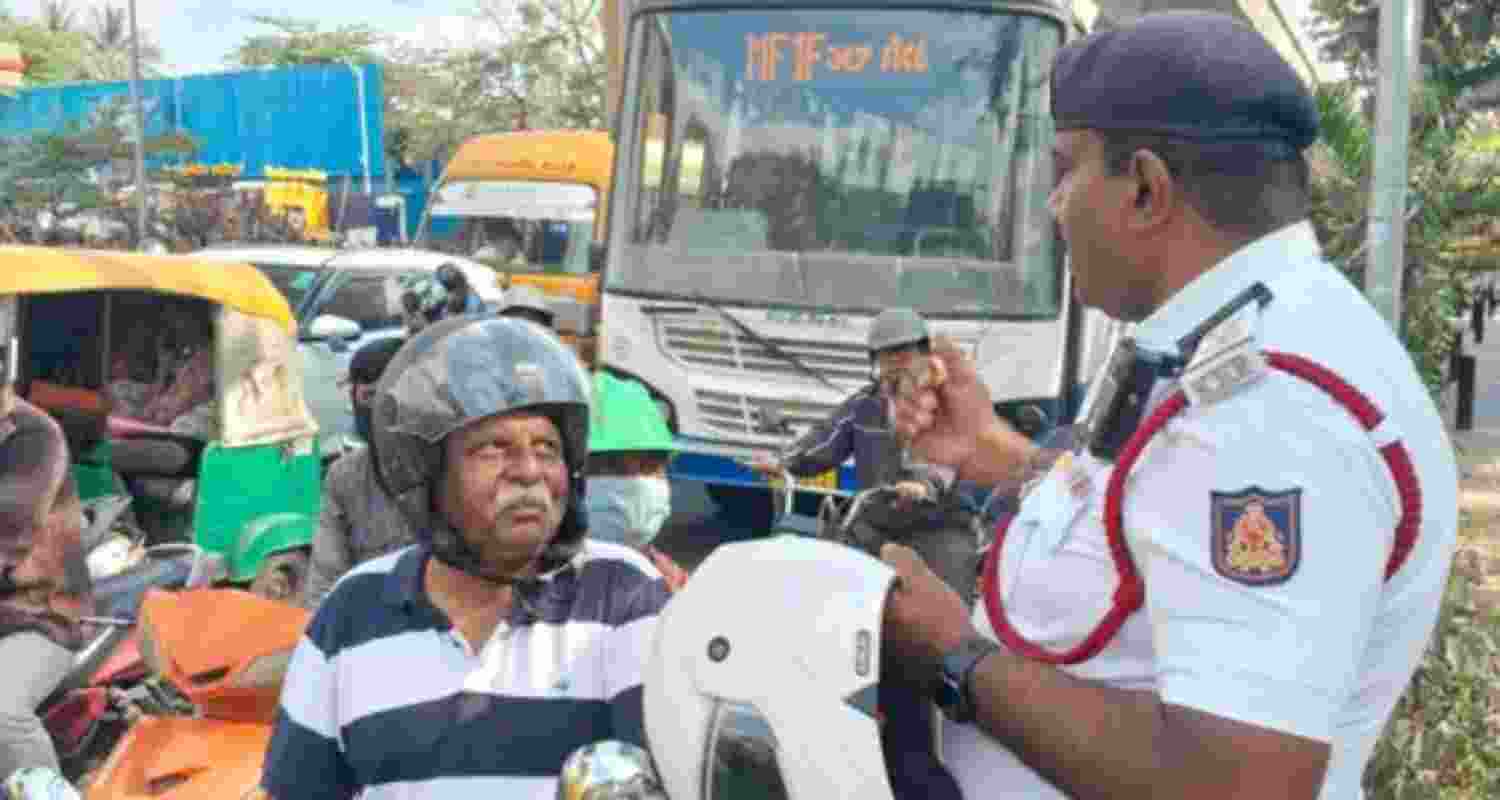 Court tells traffic violator to hold safety placards for 15 days