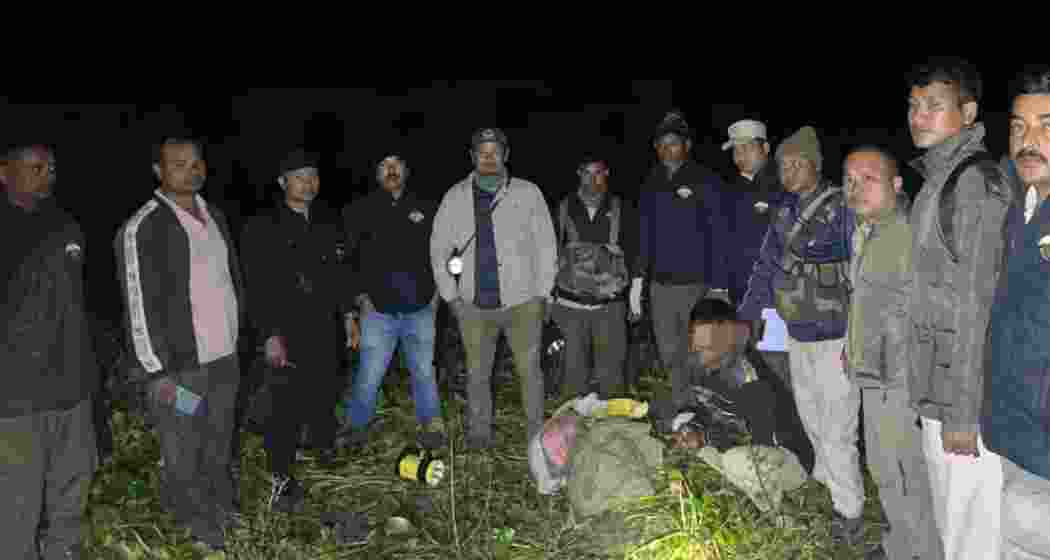 Assam Forest Department officials display seized tiger bones along with the accused poachers, following a raid near Kaziranga Tiger Reserve.