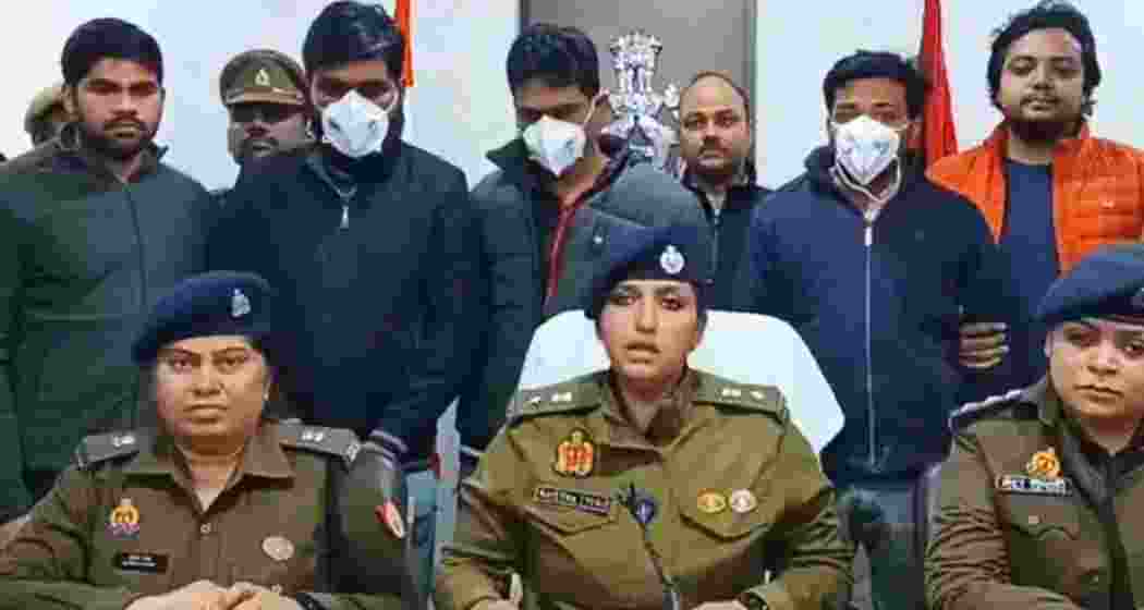 The three arrested gang members stand behind as police brief the media about the botched murder plot that led to the killing of an innocent taxi driver in Lucknow.