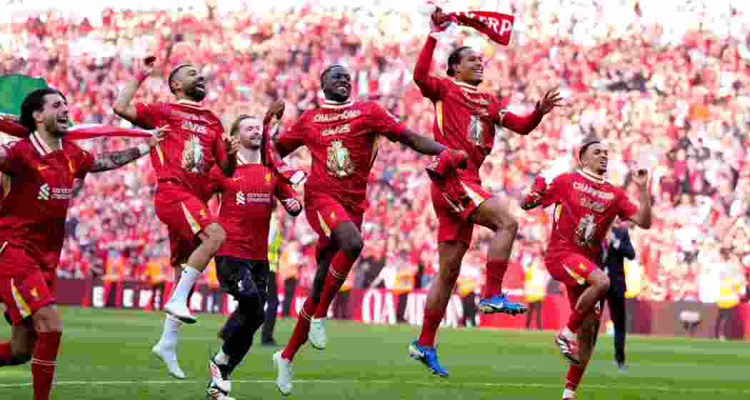 Liverpool players celebrate winning the Premier League following Sunday's dominant 5-1 victory over Tottenham Hotspur at Anfield.  