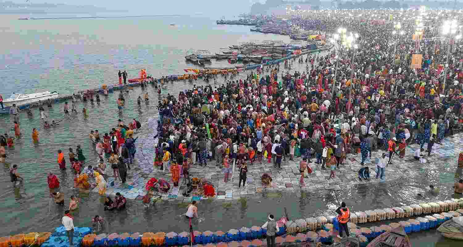 In this image, people take a holy dip at Sangam on the occasion of 'Maha Shivaratri', in Prayagraj.