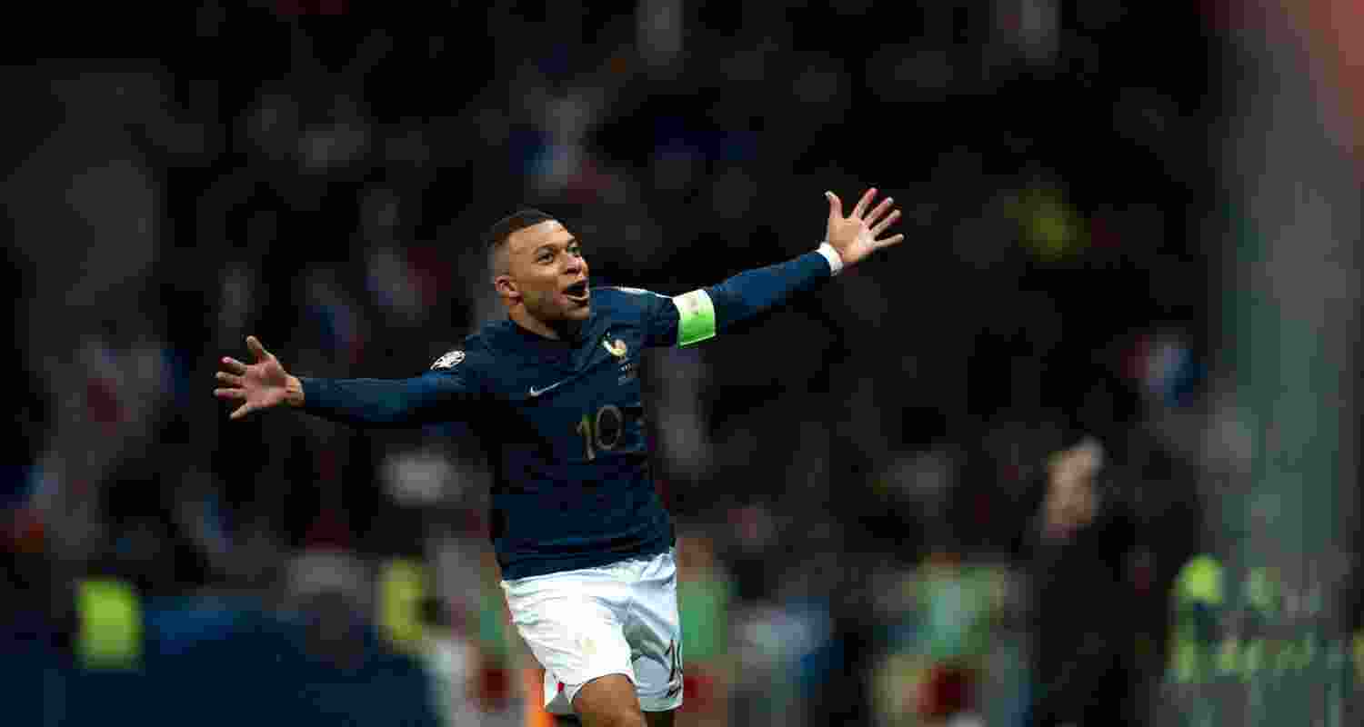 Kylian Mbape dressed in PSG jersey celebrating a goal.