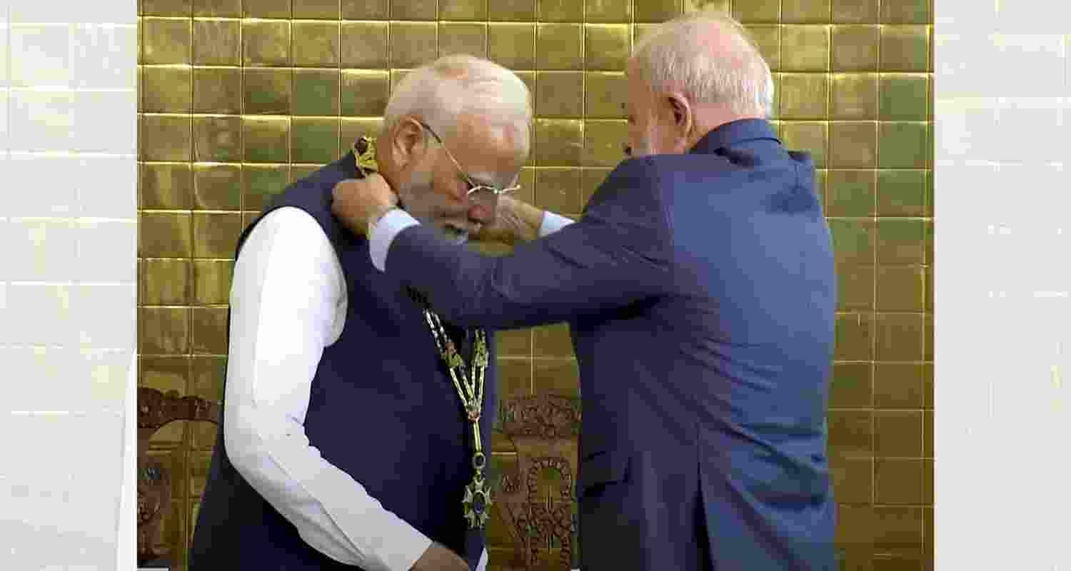 Prime Minister Narendra Modi being conferred with Brazil's highest civilian award, the Grand Collar of the National Order of the Southern Cross, by Brazil's President Luiz Inacio Lula da Silva during a ceremony, in Brasilia, Brazil, Tuesday.
