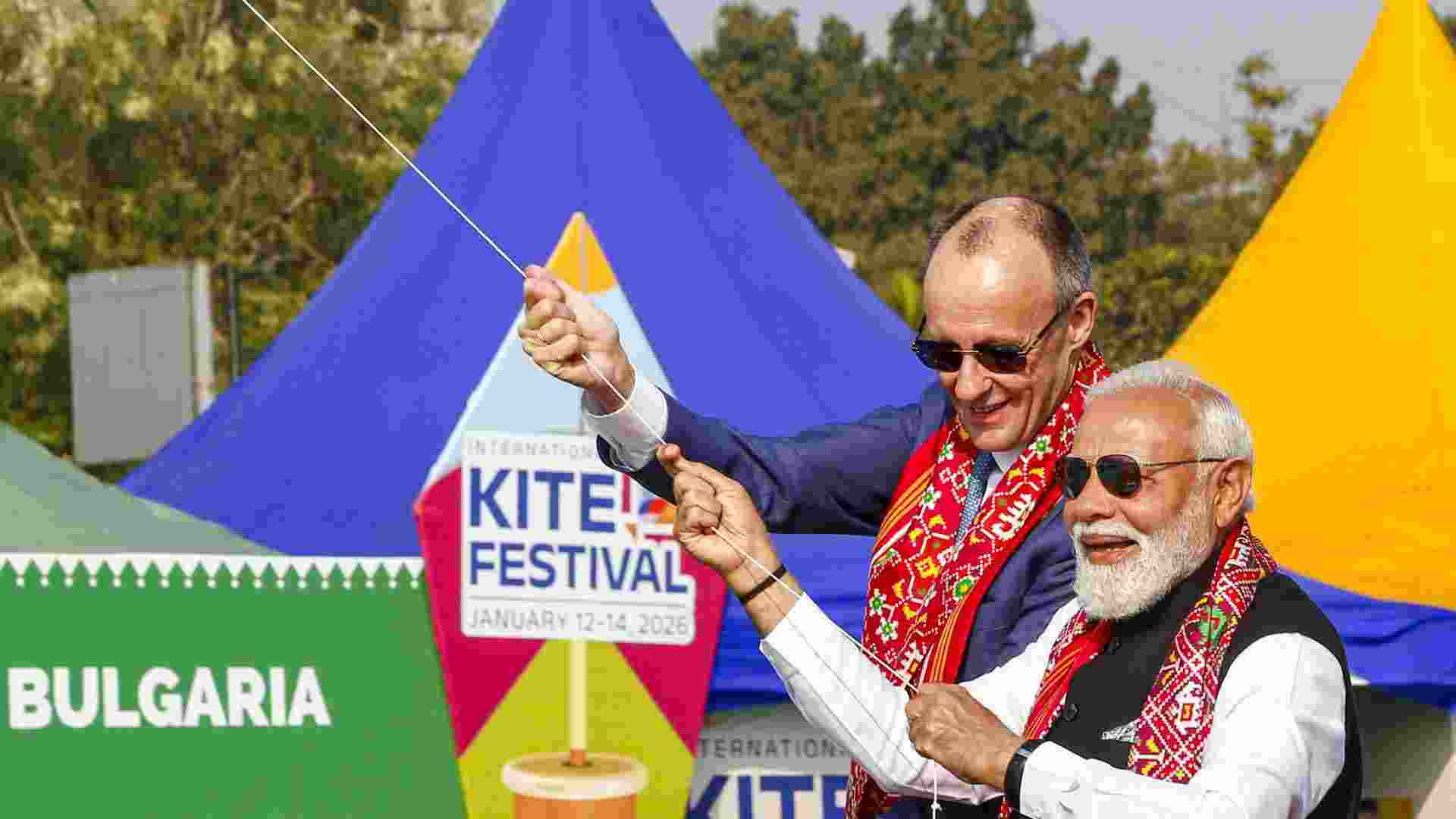 Prime Minister Narendra Modi and German Chancellor Friedrich Merz participate in the International Kite Festival at Sabarmati Riverfront, flying kites together ahead of bilateral talks, in Ahmedabad, Monday.