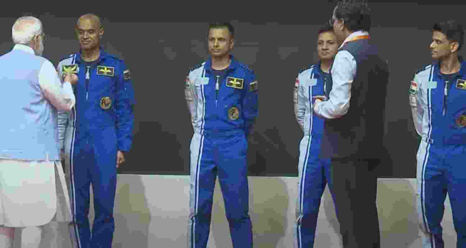 Prime Minister Narendra Modi hands-over wings to astronauts-designate Shubanshu Shukla, Prashanth Balakrishnan Nair, Angad Prathap and Ajit Krishnan who have been selected to be the astronauts on India's first crewed mission to space 'Gaganyan Mission', at the Vikram Sarabhai Space Centre (VSSC), in Thiruvananthapuram onTuesday.