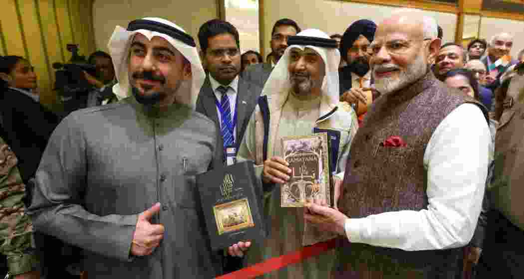 Prime Minister Narendra Modi with Abdullah Al-Baroun and Abdul Lateef Al-Nesef, the translators of the Mahabharata and Ramayana into Arabic, during his visit to Kuwait on December 21.
