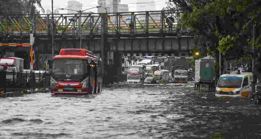 Vehicles move on a flooded road after heavy monsoon rainfall, in Mumbai, Monday. Vehicles move on a flooded road after heavy monsoon rainfall, in Mumbai, Monday.