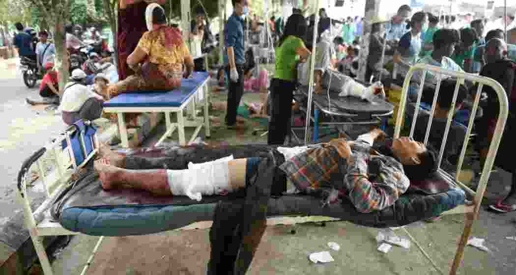 Injured survivors receive medical aid at a temporary shelter after a powerful earthquake struck Myanmar on Friday, claiming at least 694 lives. Tremors were felt in India, Bangladesh, and China.