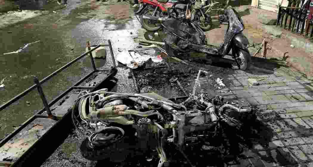 Charred remains of two-wheelers lie on a roadside on March 18, 2025 in the aftermath of a violence that erupted on March 17, 2025, in Nagpur. 
