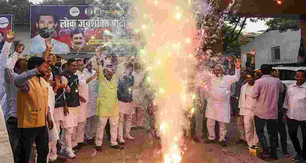 Lok Janshakti Party (Ramvilas) supporters celebrate after NDA victory in Maharastra and Bihar assembly by polls, in Patna, Saturday, Nov. 23, 2024. 
