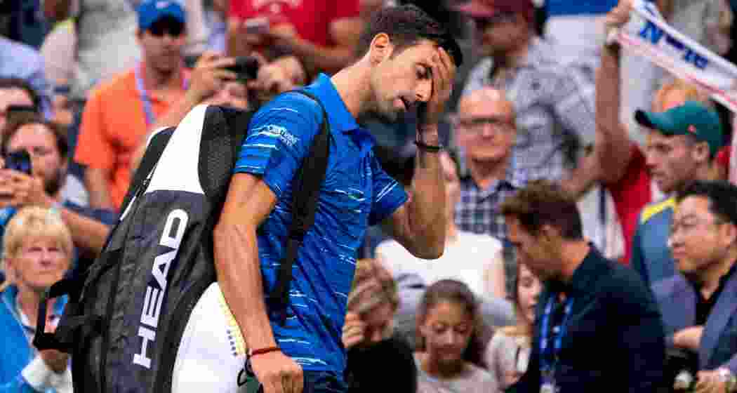Tennis star Novak Djokovic leaves after retiring due to injury in the semi-final against Alexander Zverev at the Australian Open 2025, handing Zverev a spot in the final.