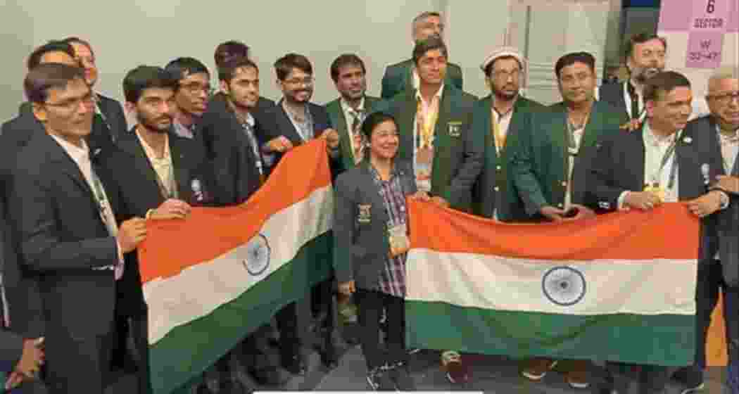 Pakistani chess players pose with the Indian flag during a post-tournament photo session at the Chess Olympiad 2024 in Budapest.