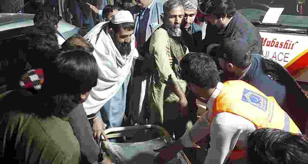 Rescue workers and volunteers help victims of a bomb explosion upon his arrival at a hospital, in Bannu, northwest Pakistan, Tuesday, March 4, 2025.