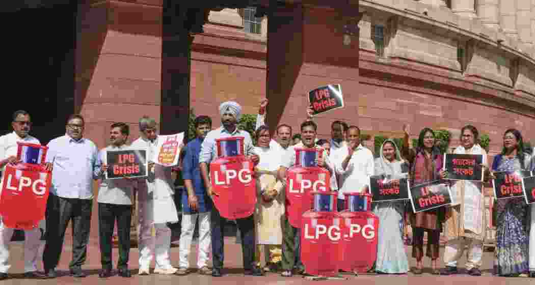 Congress MPs Amrinder Singh Raja Warring, Hibi Eden, TMC MP Dola Sen, and others stage a protest over "LPG crisis" during the second part of Budget session of Parliament, in New Delhi on Friday.