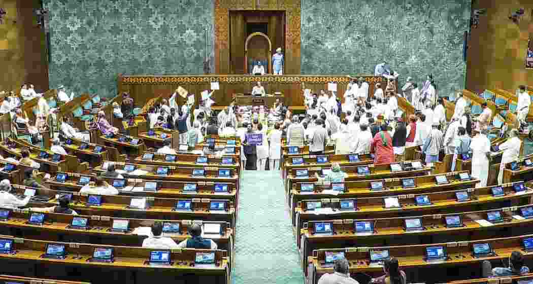 Opposition MPs protest in the Lok Sabha during the Monsoon session of Parliament, in New Delhi on Friday.