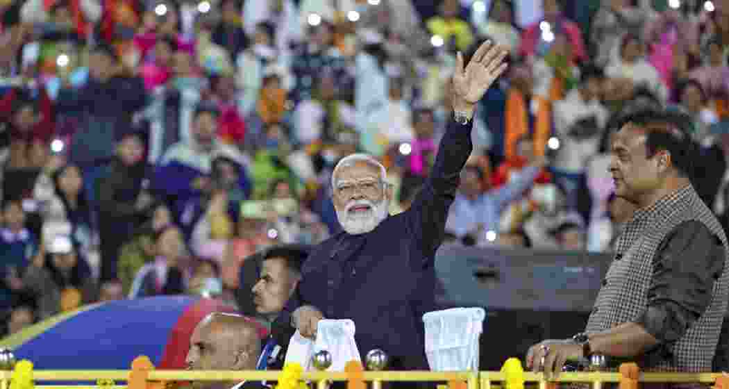 Prime Minister Narendra Modi with Assam Chief Minister Himanta Biswa Sarma waves to the gathering during Traditional Bodo Cultural Programme, in Guwahati. 
