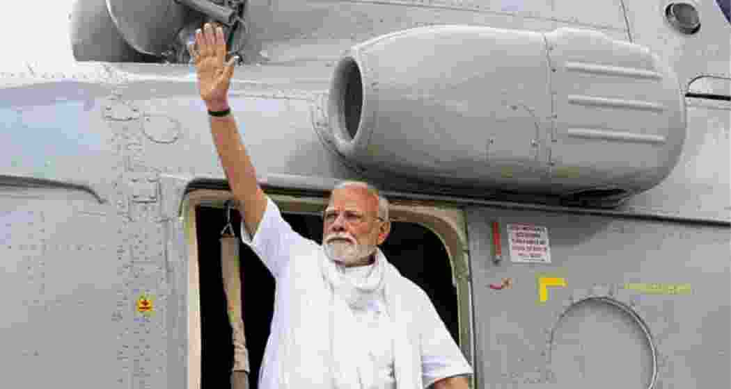 Prime Minister Narendra Modi waves as he arrives to address a public meeting, in Varanasi. 