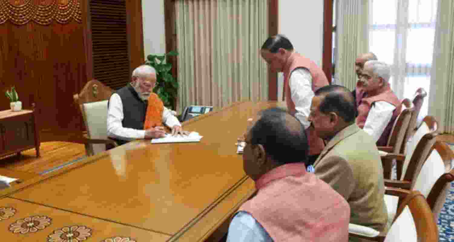 Prime Minister Narendra Modi signs a document - file image. Prime Minister Narendra Modi signs a document - file image.