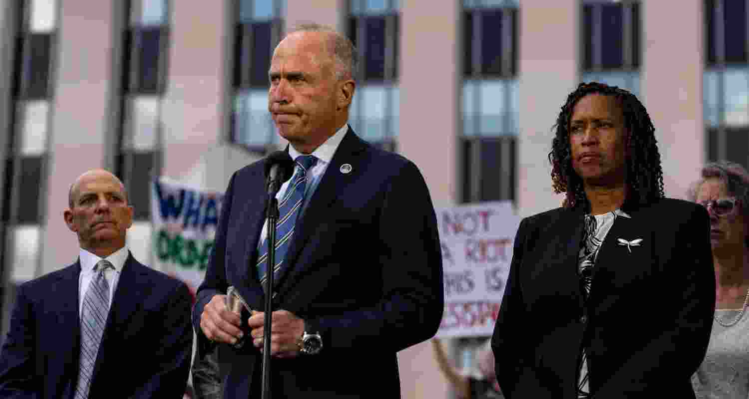 D.C. Attorney General Brian Schwalb and Mayor Muriel E. Bowser speak to the press outside the U.S. District Court in Washington on Friday.