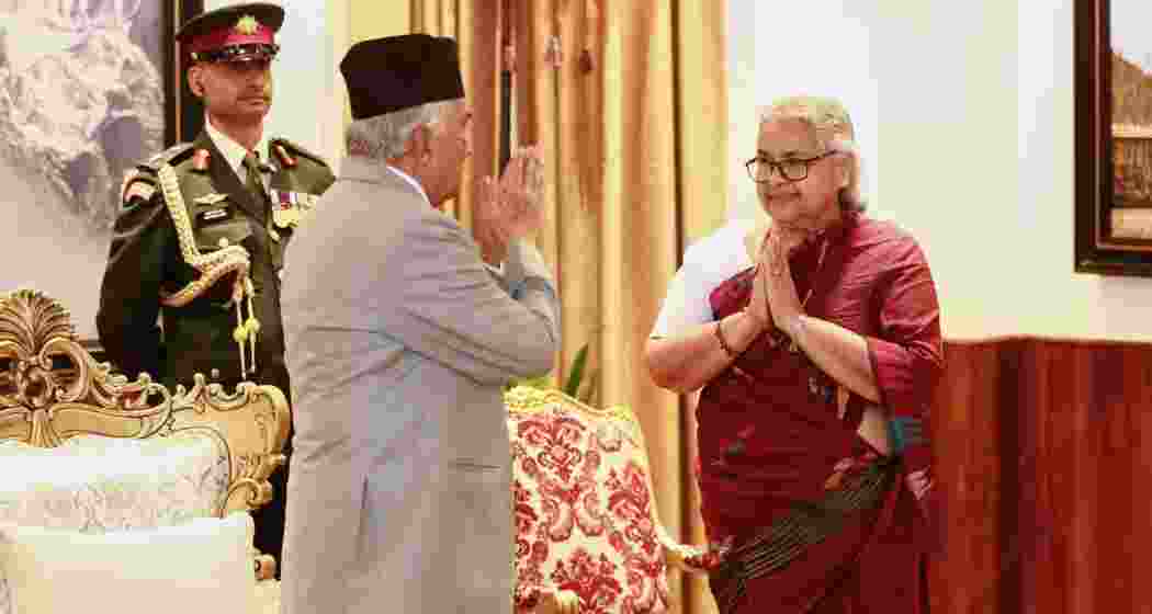 Former Supreme Court Chief Justice Sushila Karki, right, greets Nepalese President Ram Chandra Poudel after taking the oath as interim prime minister.