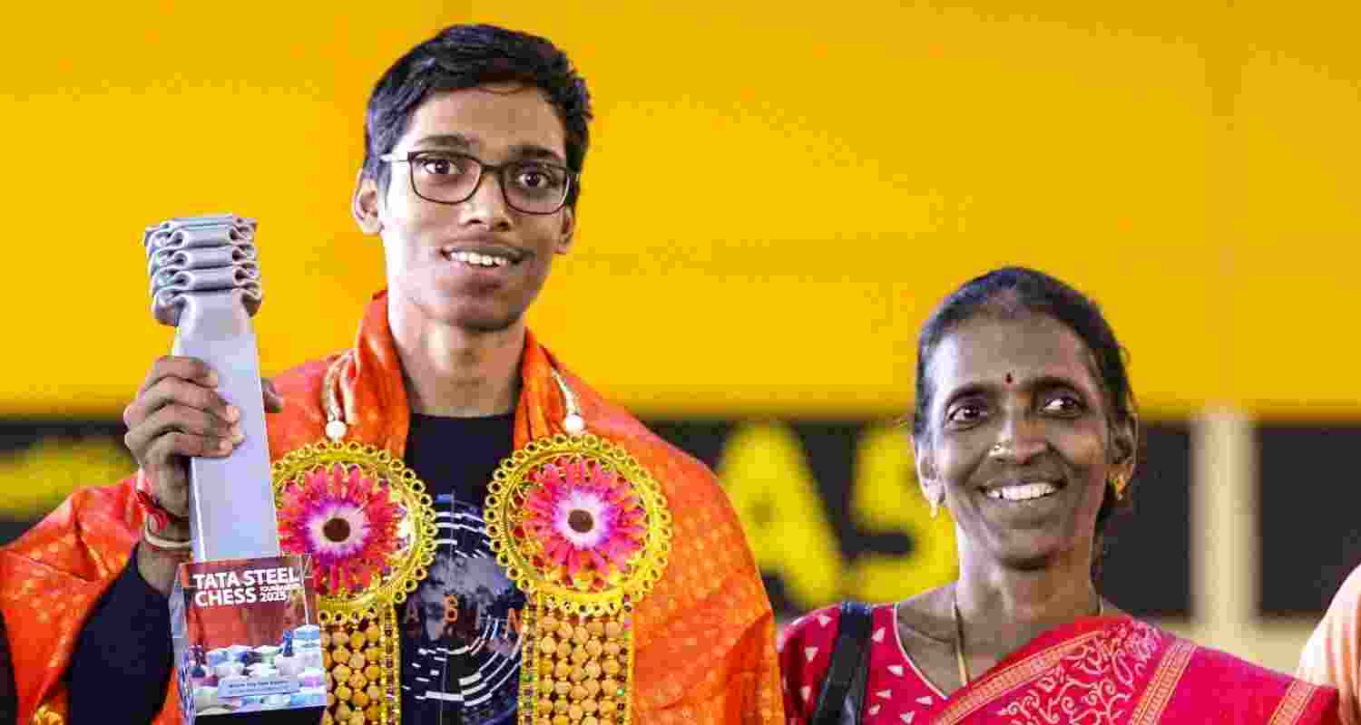 Indian grandmaster R Praggnanandhaa with his mother at the New Delhi airport.