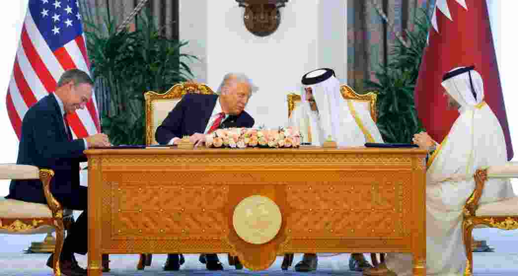 US President Donald Trump, Qatar's Emir Tamim bin Hamad Al Thani and Boeing CEO Kelly Ortberg attend a signing ceremony in Doha, Qatar on May 14, 2025.