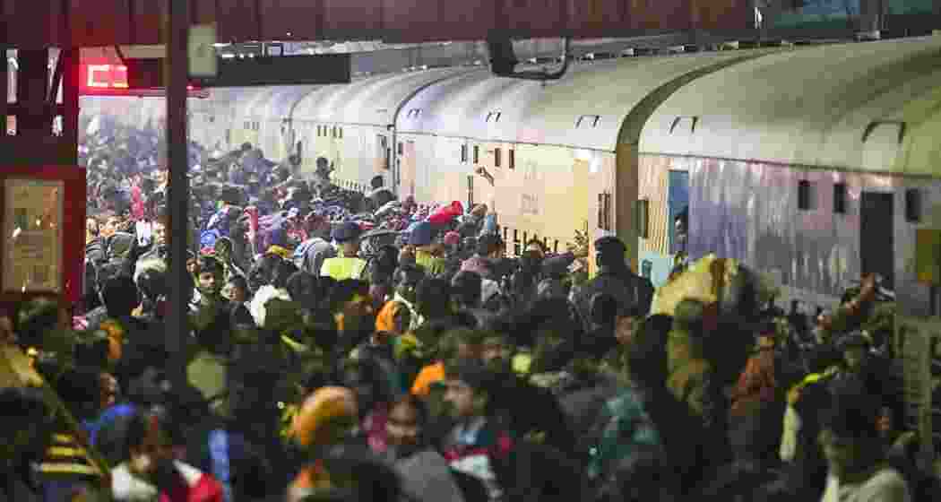 Passengers board an overcrowded train for Prayagraj's Mahakumbh, at the New Delhi railway station, Saturday, Feb. 15, 2025. At least 18 people were killed and more than a dozen injured in a stampede that broke out late Saturday night at the crowded railway station. (PTI Photo)
