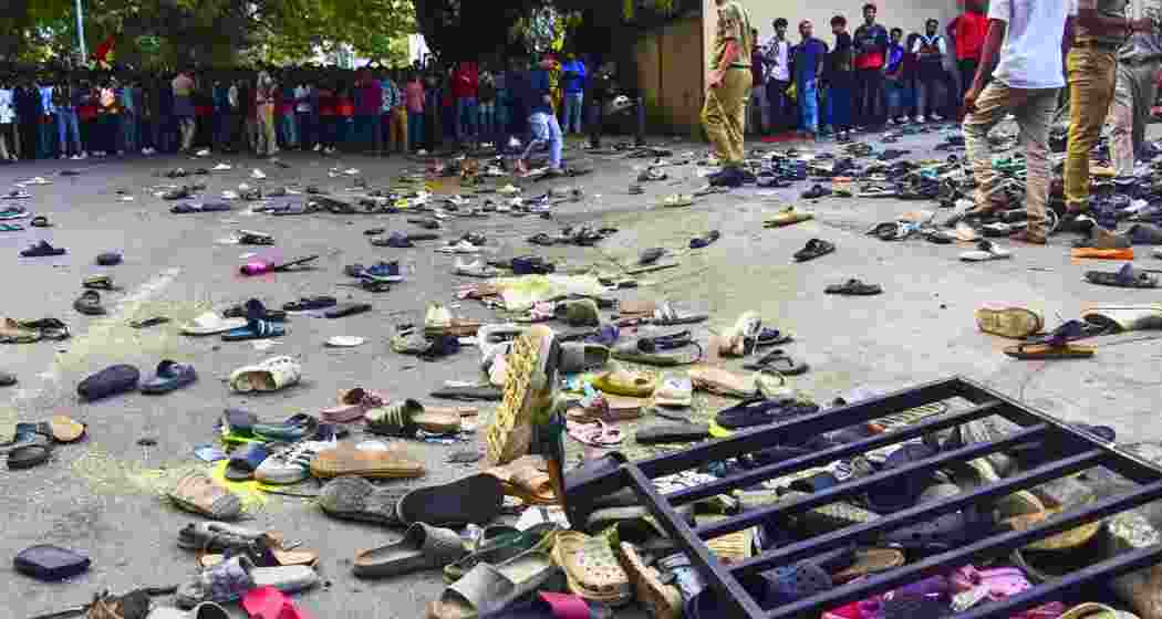 Footwears lie on the ground outside the Chinnaswamy Stadium following a stampede after a large number of fans gathered for the felicitation of IPL 2025-winning Royal Challengers Bengaluru team, in Bengaluru, Karnataka, Wednesday, June 4, 2025. At least eleven people were killed, and several others suffered injuries in the incident.
