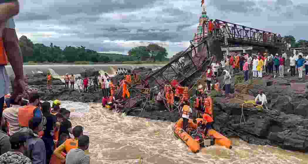 Rescue workers at the site of the collapsed Indrayani River bridge in Pune district.